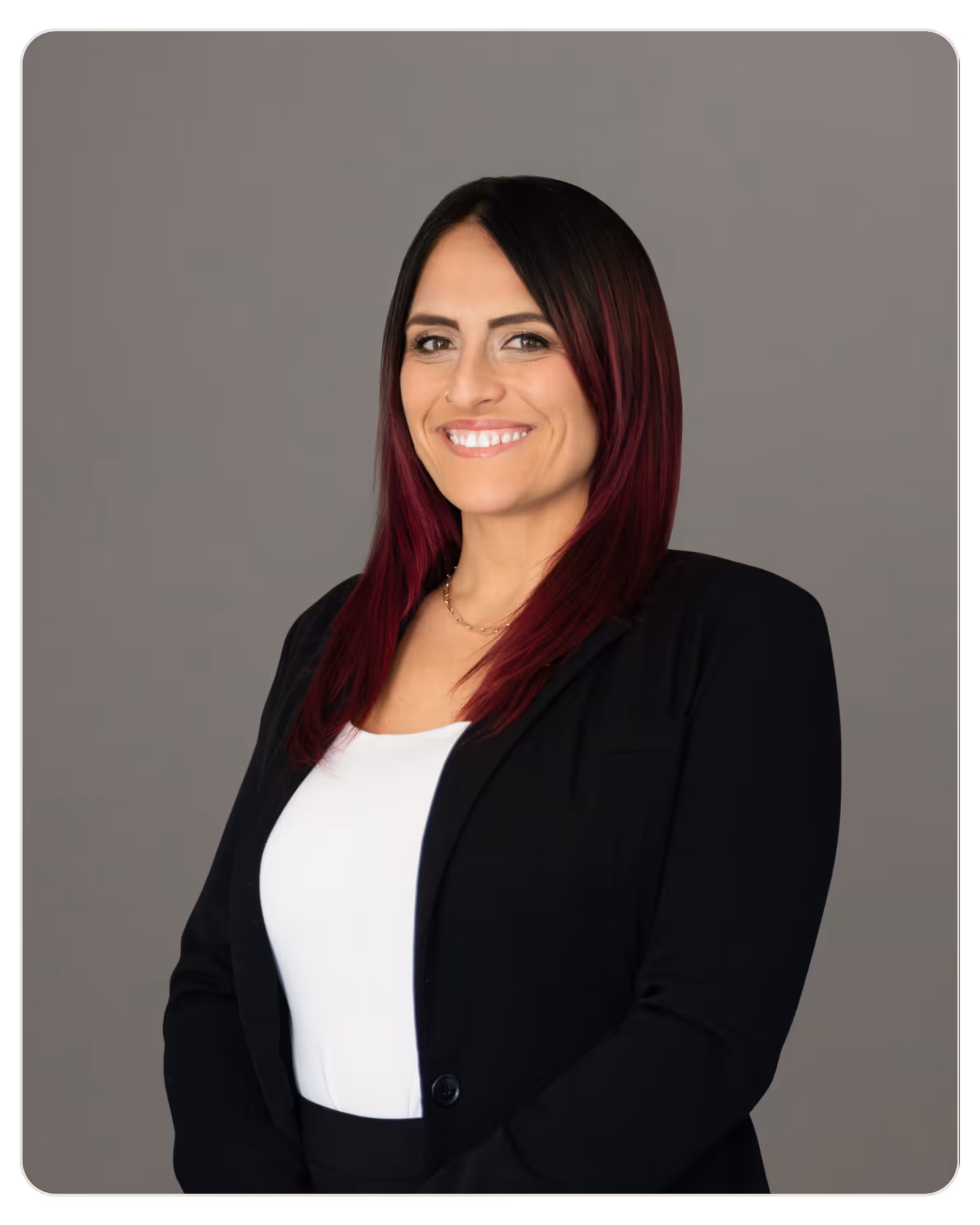 Kourtney Stefanu, RN: Director of Operations at Kandela. Professional headshot of a smiling woman in a black blazer and white top against a gray backdrop