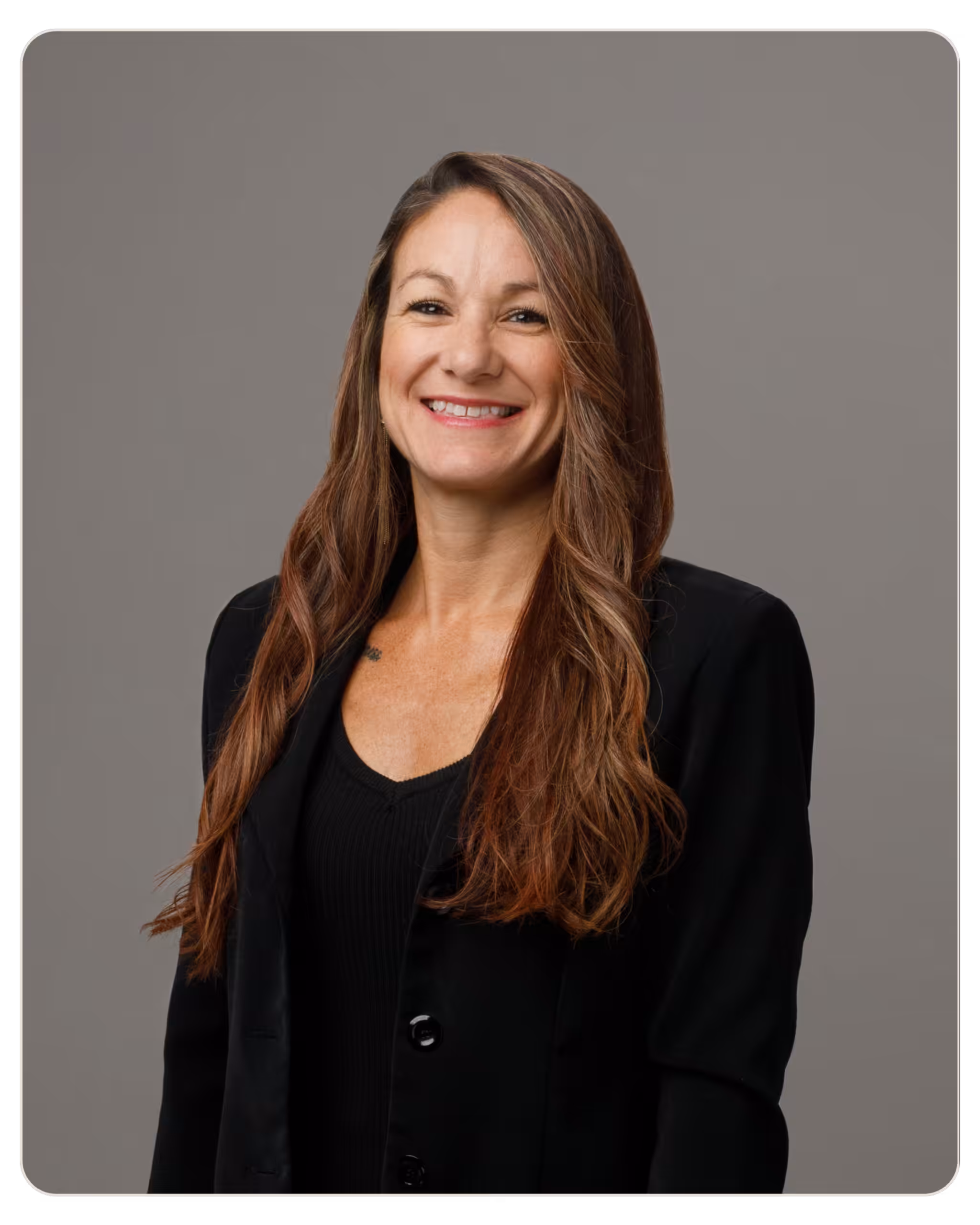 Rachel Vargas, LMHC: Clinical Director at Ember. Smiling woman with long brown hair in a black blazer against a gray studio backdrop.